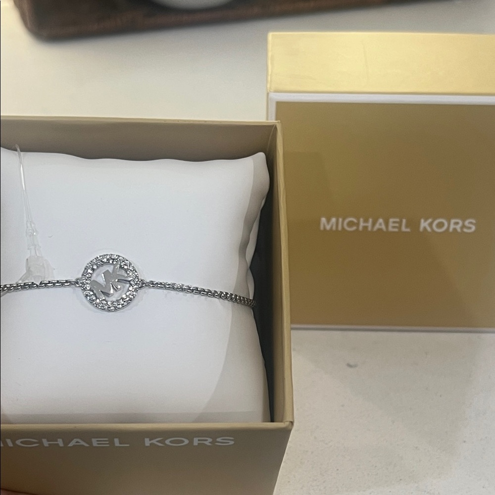 Michael Kors Silver Bracelet with MK Logo. Adjustable strap NIB $85 retail.